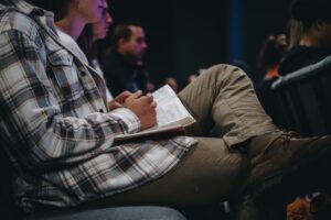 Man sitting in a chair with a Bible in his lap
