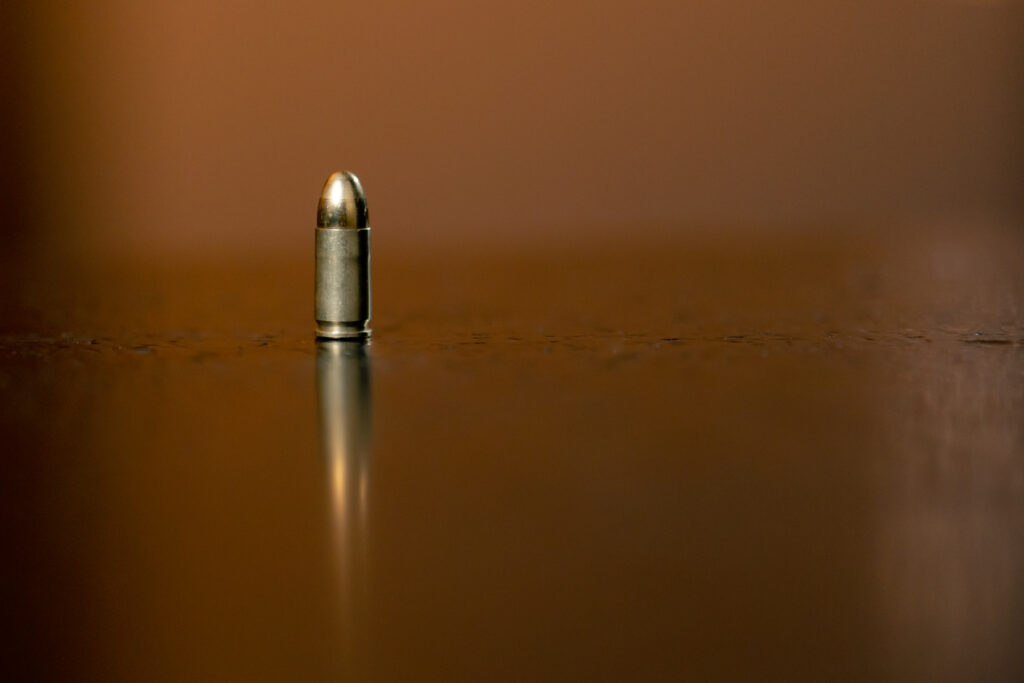 silver bullet on a reflective surface