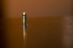 silver bullet on a reflective surface